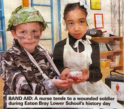 A nurse tends to a wounded soldier during Eaton Bray Lower School's History Day